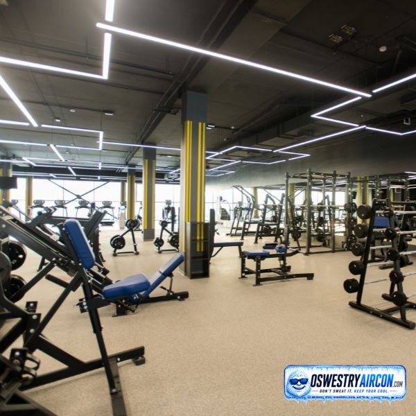 Ceiling-mounted air conditioning unit being installed in a gym for efficient cooling and ventilation &ndash; Oswestry
