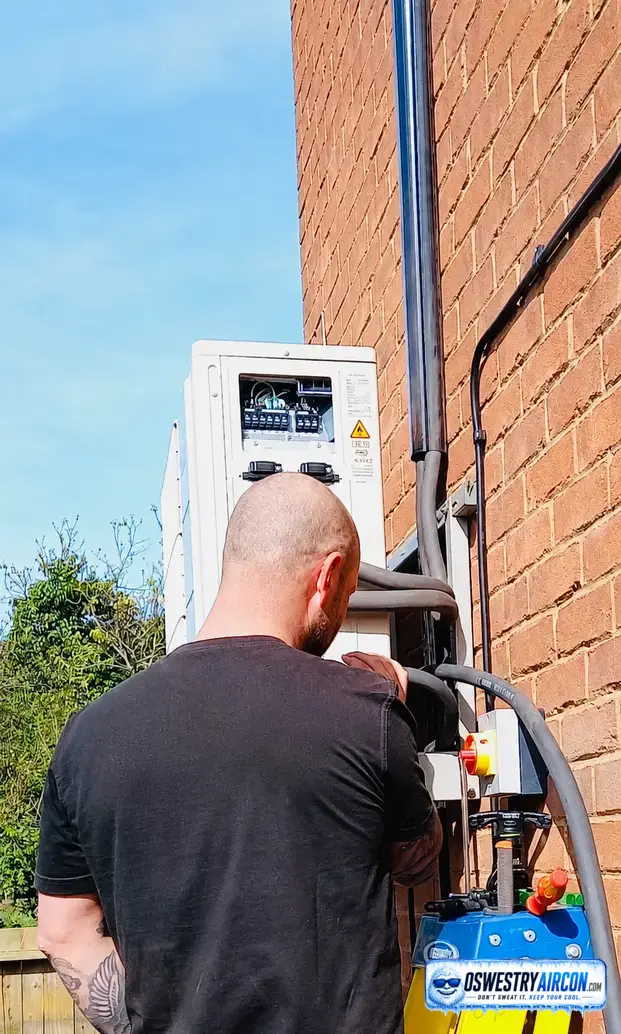 Oswestry Air Conditioning engineer checking operating codes to troubleshoot an air conditioning system.